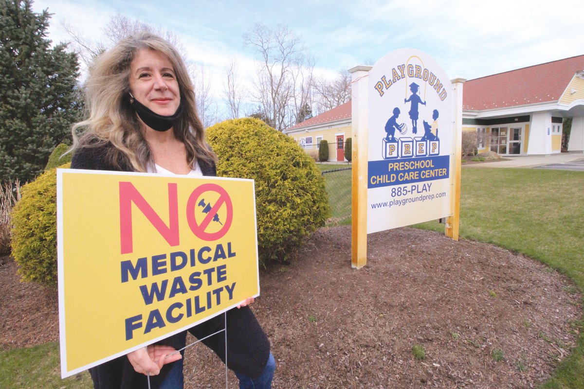 IS THIS A GOOD SITE? Denise Lopez, who is leading the charge to stop medical waste processing operation on Division Street in West Warwick, stands in front of the Playground pre-school, which is a neighbor to the proposed facility.